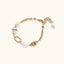 Golden Pearl Link Bracelet with freshwater pearls and 14K gold-plated chain links on a cream background
