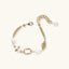 Close-up of 14K gold-plated eco-brass bracelet with freshwater pearls, textured links and adjustable clasp