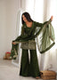 Model wearing the Mehendi green embroidered bell bottom suit set while holding the matching dupatta, full styling view.