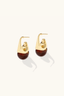 Angled view of Amber Flow Drops gold plated resin earrings showing shape and warm amber tone