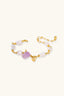 Stretch wrap bracelet laid flat showing multicolour gemstone beads, pearls and gold centre section