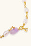 Close-up of green stone centrepiece and crystal butterfly charm on pearl gemstone bracelet