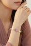 Bracelet worn by a model 1 as a double-wrap stack with pastel beads, pearls and butterfly charm