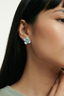 Model wearing blue enamel floral stud earrings