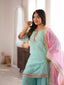 Model wearing the Mira mint embellished sharara suit set with pink dupatta, upper body front view.