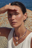 Model wearing amethyst and pearl necklace with star charm and baroque pearl drop pendant
