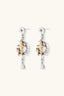 Side view of two-tone celestial drop earrings with sterling silver posts and pear-cut zirconia