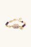 Angled view of gold plated amethyst and pearl bracelet with central baroque pearl and star charm