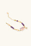 Flat lay of adjustable amethyst bead and pearl bracelet with baroque pearl centre and gold star charm