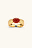 Crimson Crown Ring styled with a rust-toned top, close-up beauty setting
