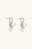 Front view of crystal bow pearl drop earrings in rhodium-plated 925 sterling silver.
