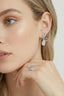 Model wearing rhodium-plated sterling silver crystal bow pearl drop earrings.