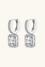 Emerald cut moissanite halo drop earrings in 925 sterling silver, angled side view.