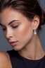 Model wearing sterling silver emerald cut moissanite halo drop earrings styled for evening look.