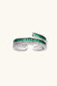 Emerald Layers Ring styled with pearl earrings and a green top, warm close-up setting