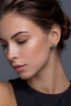 Model wearing Verdant Halo sterling silver emerald-tone moissanite stud earrings