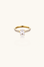 Front view of gold oval zirconia engagement style ring with pavé band