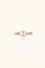 Side angle of oval zirconia gold plated ring showing pavé stone setting