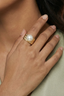 Model wearing hammered gold-plated freshwater pearl ring for an elegant everyday look
