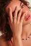 Close-up of gold-plated band, showing heart stones and clear baguette zirconia