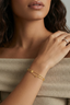 Model wearing Starluck Charm Bracelet gold plated double chain charm bracelet with clovers and stars