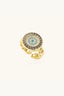 Angled view of gold plated evil eye ring with Greek key border and crystal detailing