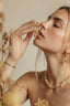 Model wearing peridot and pearl bracelet, delicate green gemstone jewellery
