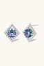 Sterling silver square halo stud earrings featuring round rainbow moissanite centre stone, angled view.