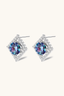 Close-up of rainbow moissanite stud earrings in sterling silver geometric halo setting.
