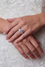 Model wearing Imperial Radiance Ring with large rainbow moissanite centre stone