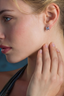 Modern square moissanite stud earrings worn by model in sterling silver