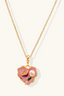 Rose Garden Heart Necklace close-up – 18K gold plated enamel heart pendant with rose detail and freshwater pearl on a cream background
