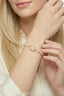 Model wearing rose quartz and pearl bracelet with gold plated setting and pastel beaded details