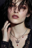 Model wearing crown statement necklace with red enamel pendant and teardrop drop