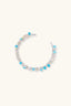 Top view of pastel open cuff bracelet with blue stones, rose quartz tones and pearl accents