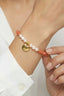 Close-up of freshwater pearls and carnelian beads, showing S925 charm detail