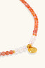 Carnelian Pearl Bracelet styled with a white shirt, wrist close-up