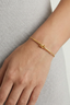 Gold knot bar bracelet worn on wrist, minimal everyday jewellery