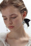 Model wearing Venice Mask Drop Earrings, front view, sculptural mask and ABS pearl drops